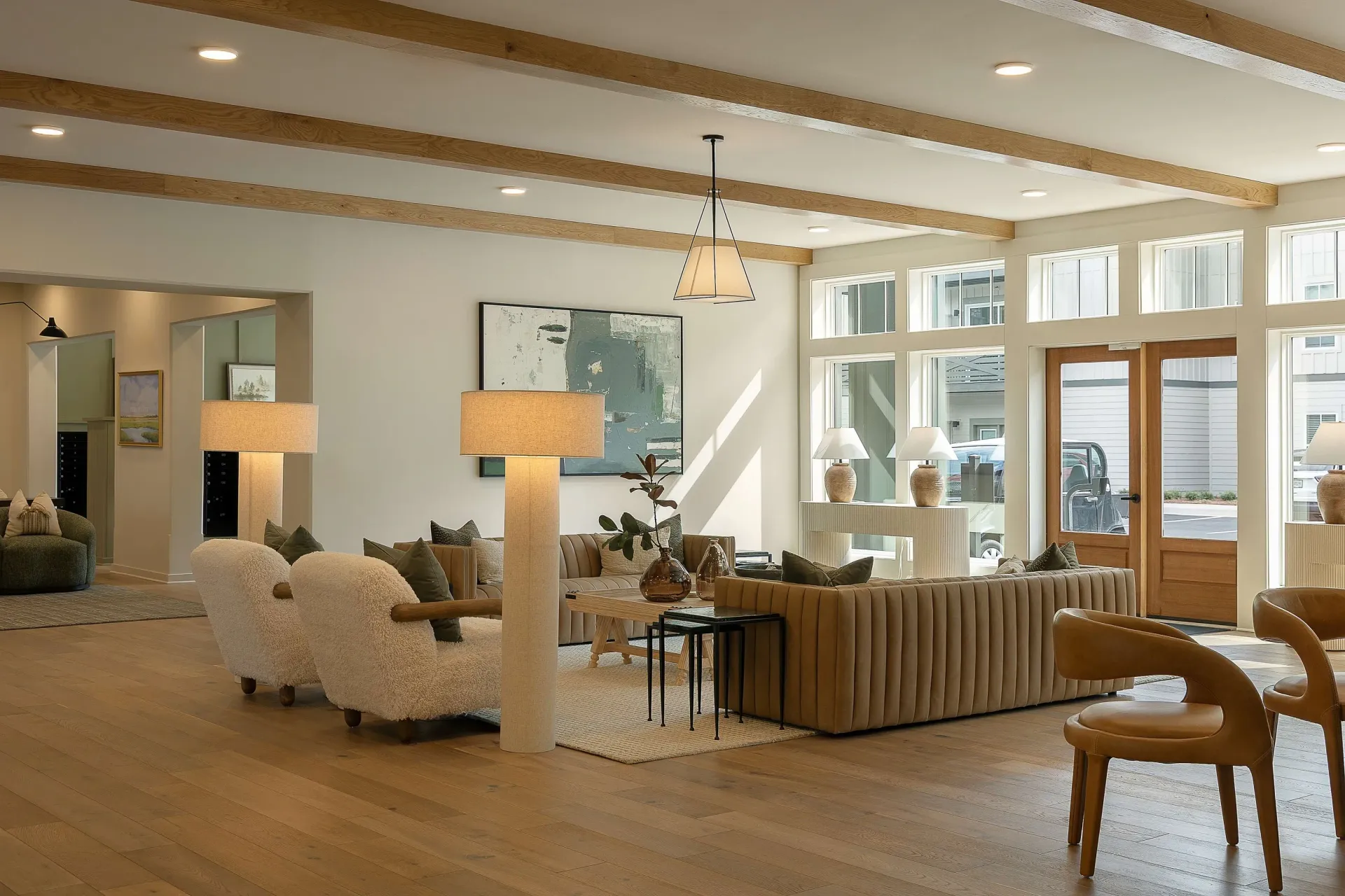 Modern lobby with comfortable seating, including sofas and armchairs, and large windows.