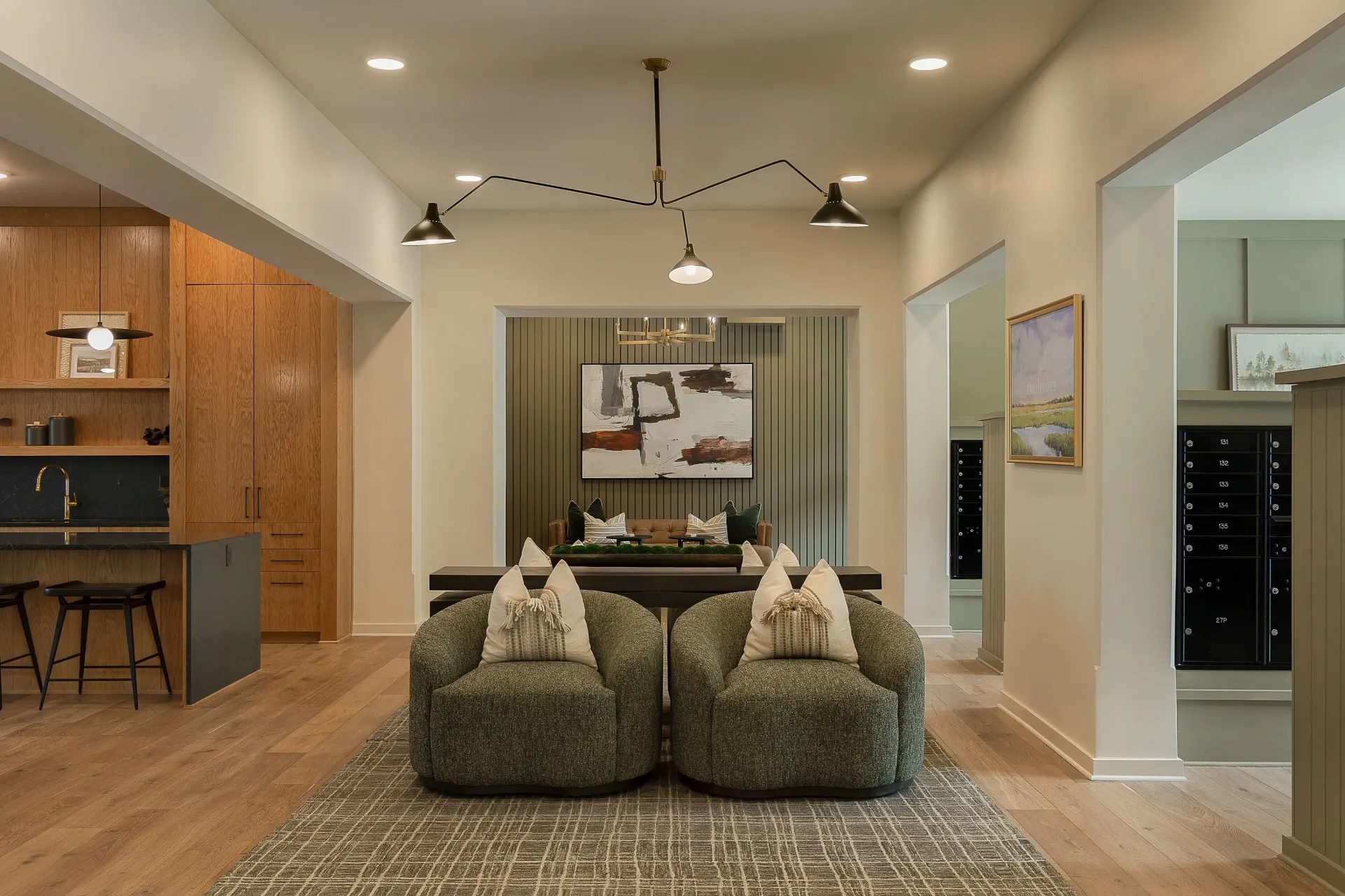 Lobby seating area with modern art and mailboxes.