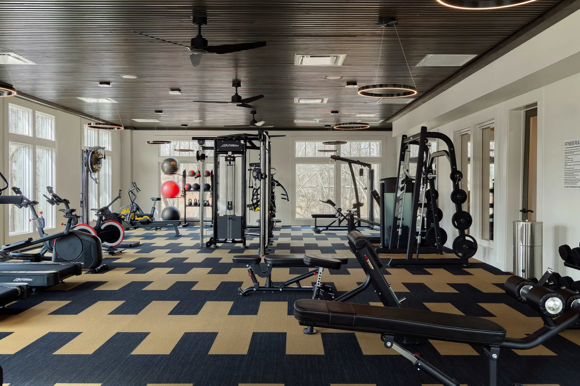 Fitness center with treadmills, stationary bikes, weight machines, and free weights.