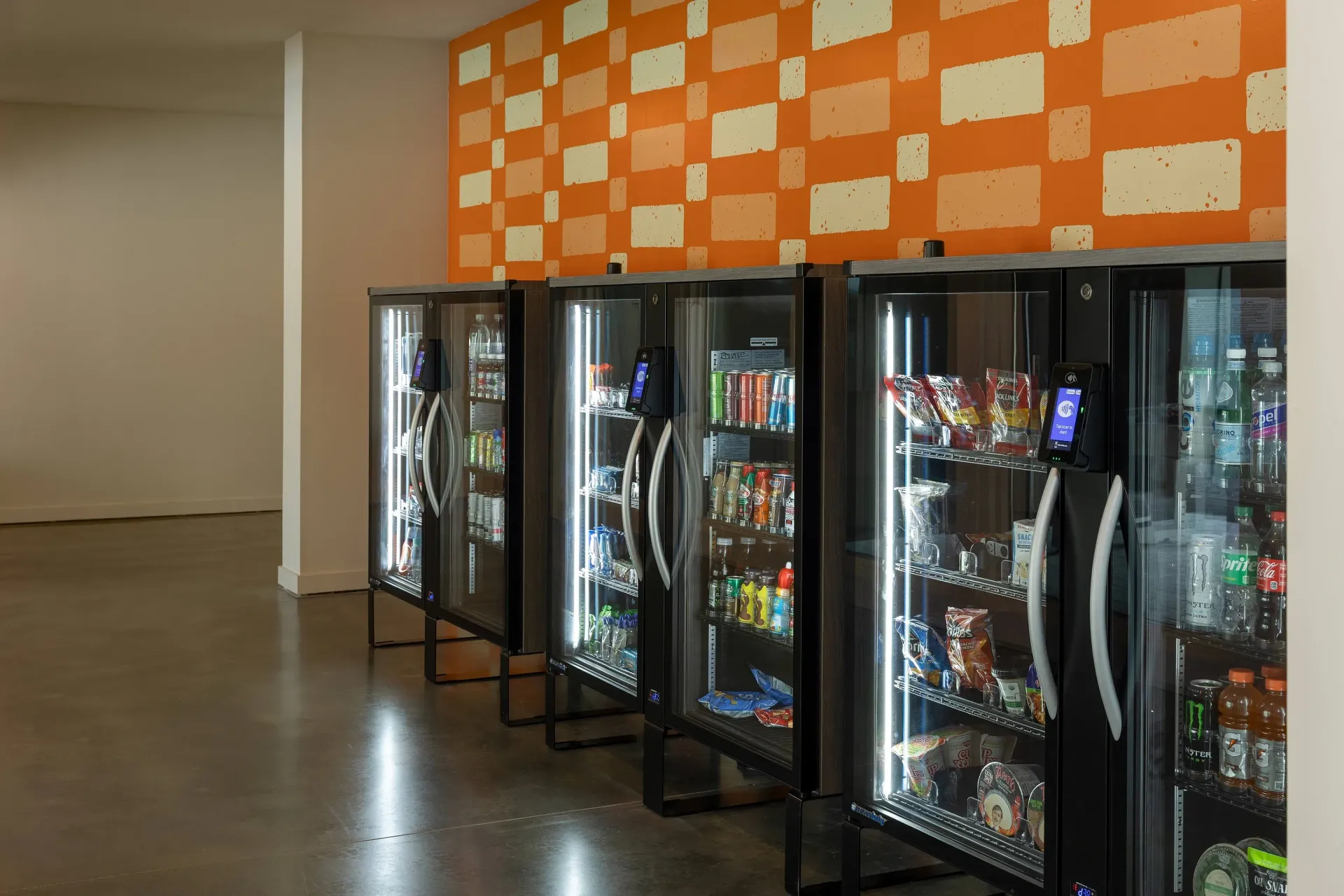Vending machines in a common area with snacks and drinks.