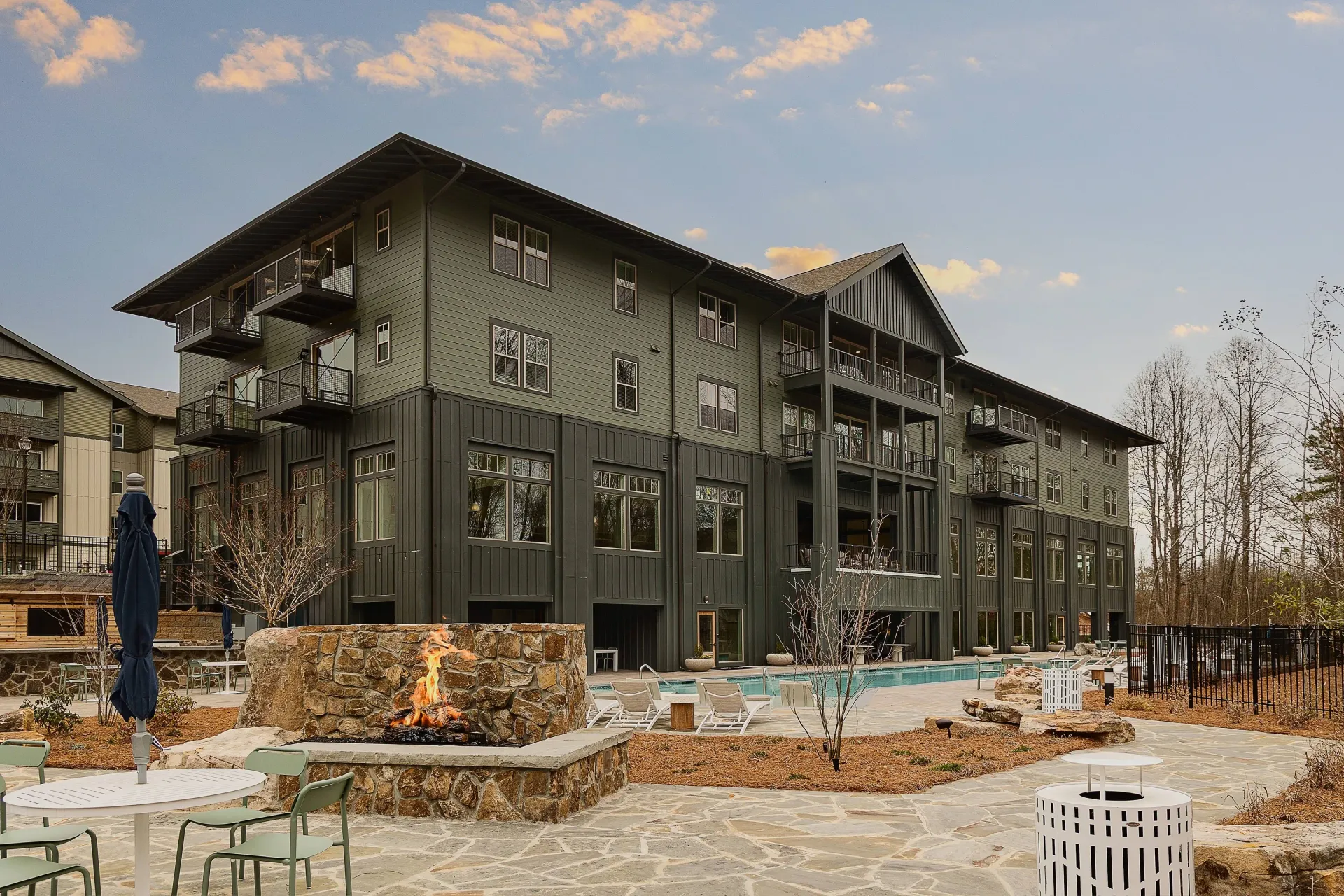 Apartment building exterior with pool and fire pit