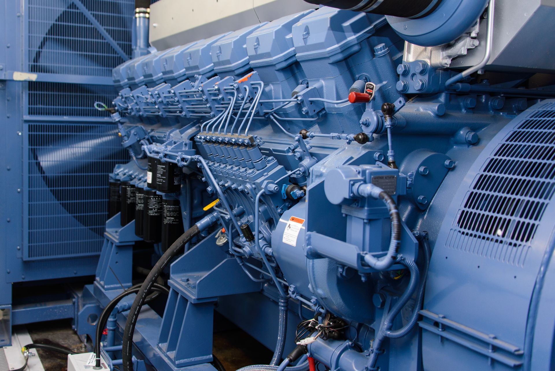 Un gros moteur bleu est assis à l'intérieur d'un bâtiment.