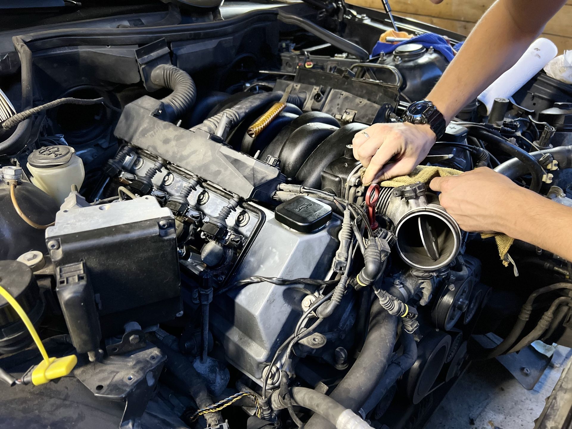 A person is working on the engine of a car.