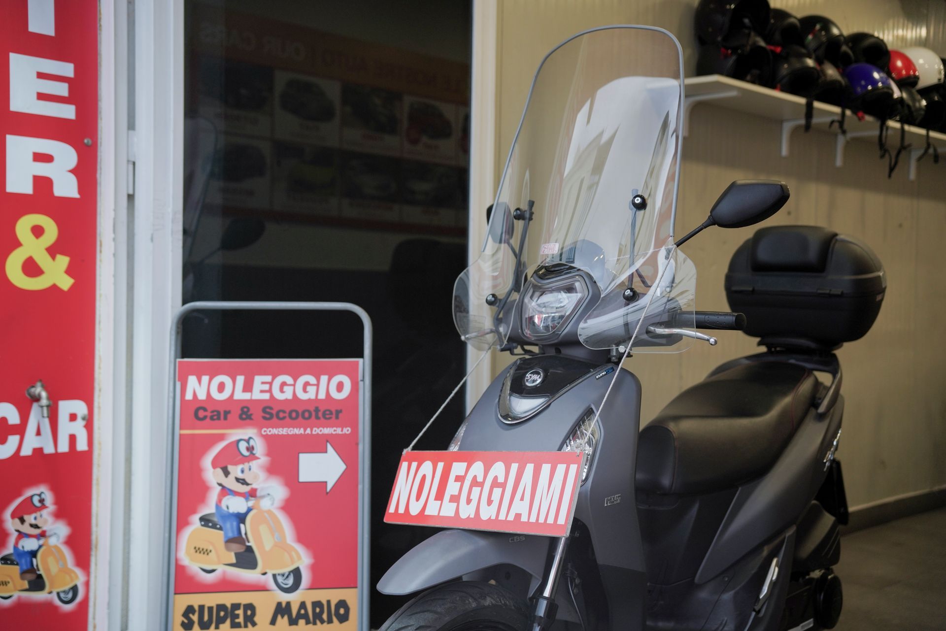 Uno scooter è parcheggiato davanti a un negozio che vende scooter di super mario