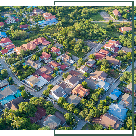 An aerial view of a residential area with lots of houses and trees. An aerial view of a residential area with lots of houses and trees.