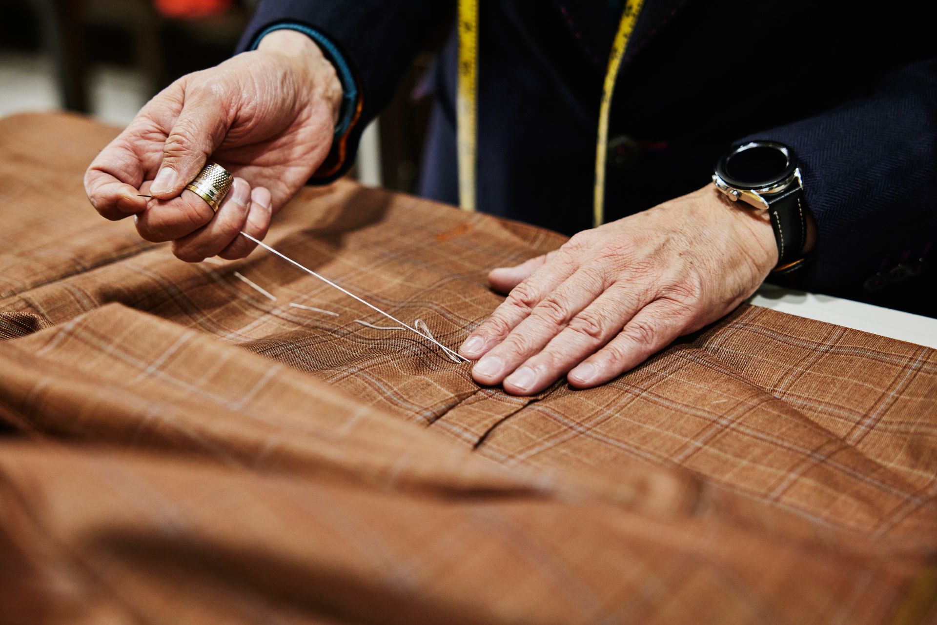 A Person Is Sewing A Piece Of Fabric With A Needle And Thread – Margate, QLD - Ocean Breeze Dry Cleaners