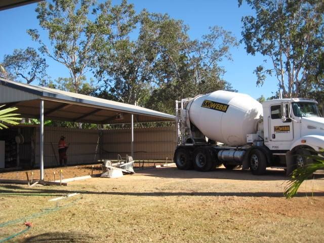 Cement Mixer Truck Parked In Front Of A Building — Diamond Concreting In Mount Low, QLD