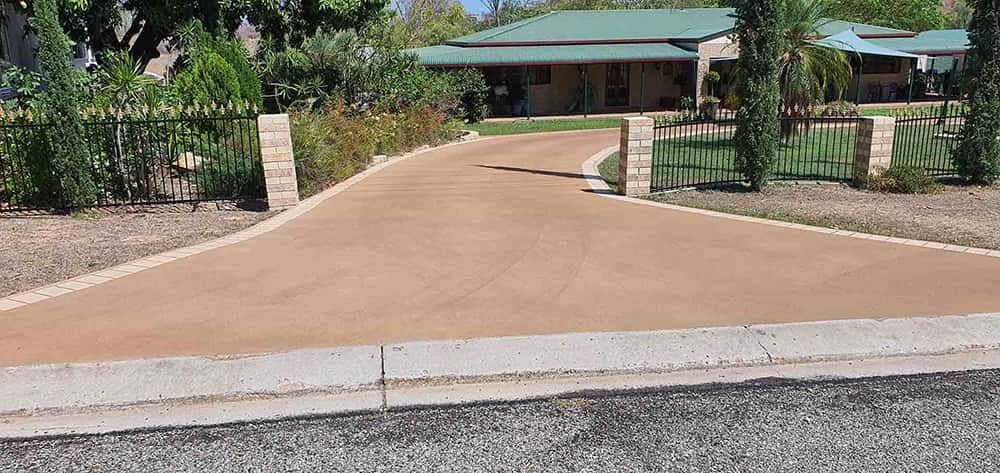 Dirt Road Leading To A House With A Green Roof — Diamond Concreting In Mount Low, QLD