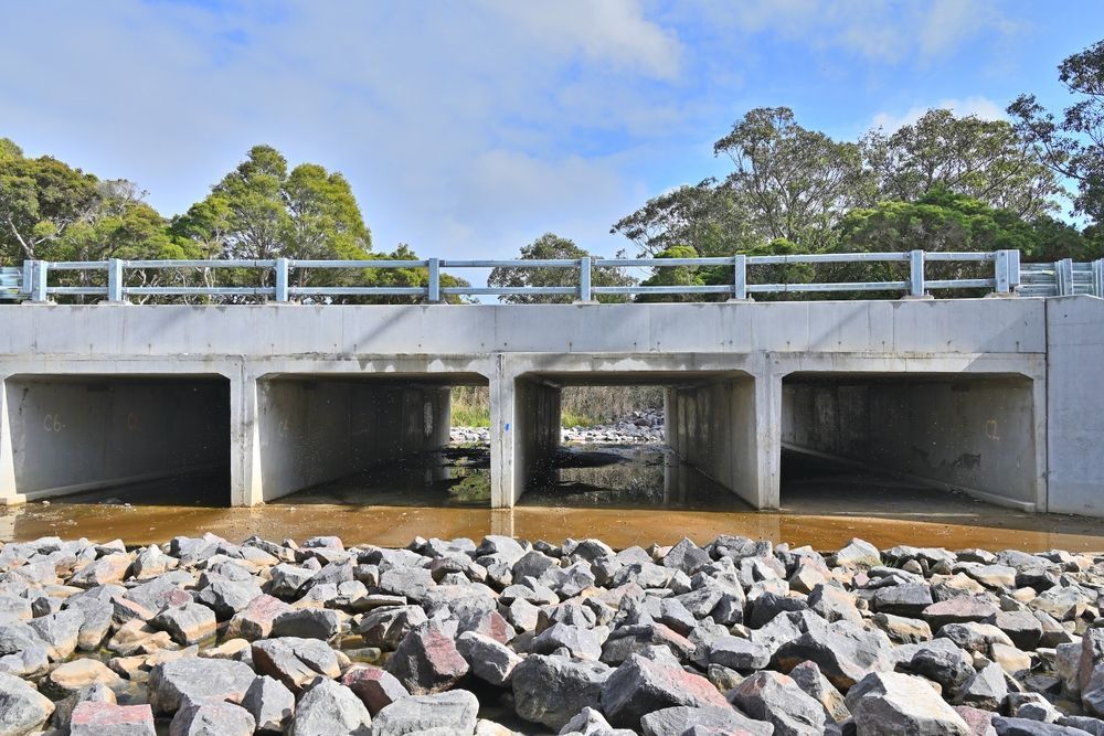 Bridge Over A River With Rocks In The Foreground — Diamond Concreting In Mount Low, QLD