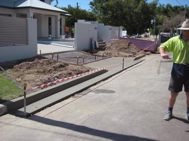 Person Sweeping The Sidewalk With A Broom And Shovel — Diamond Concreting In Mount Low, QLD