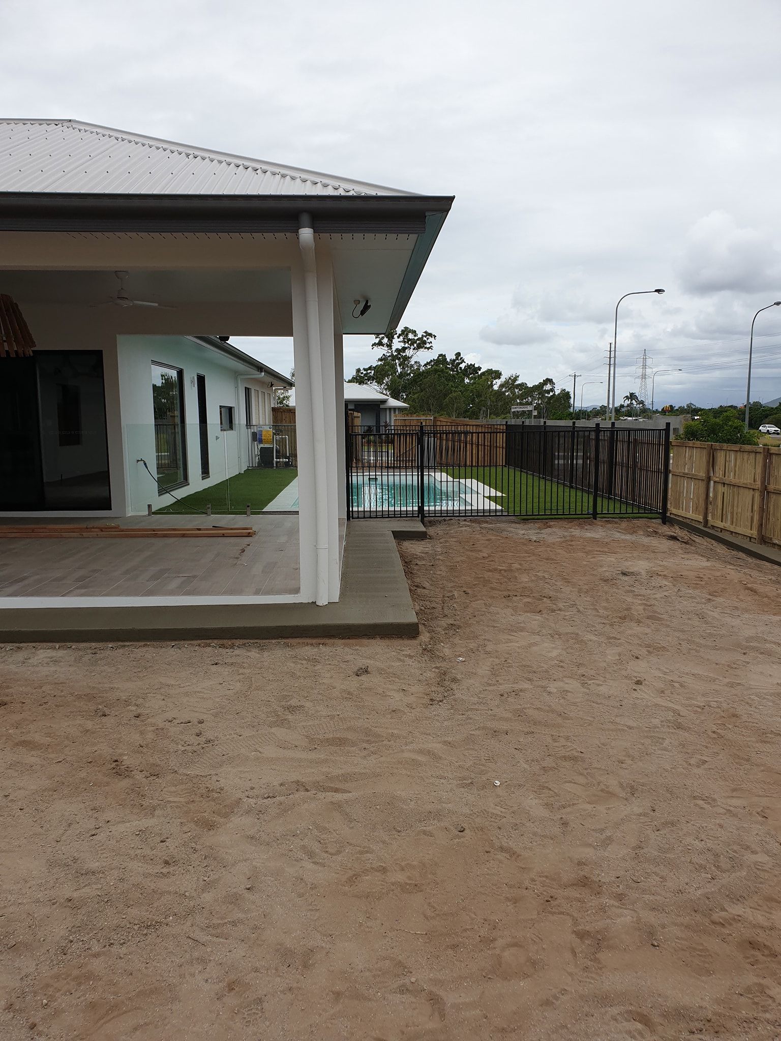 Patio With Furniture And A Fire Pit In Front Of A House — Diamond Concreting In Mount Low, QLD