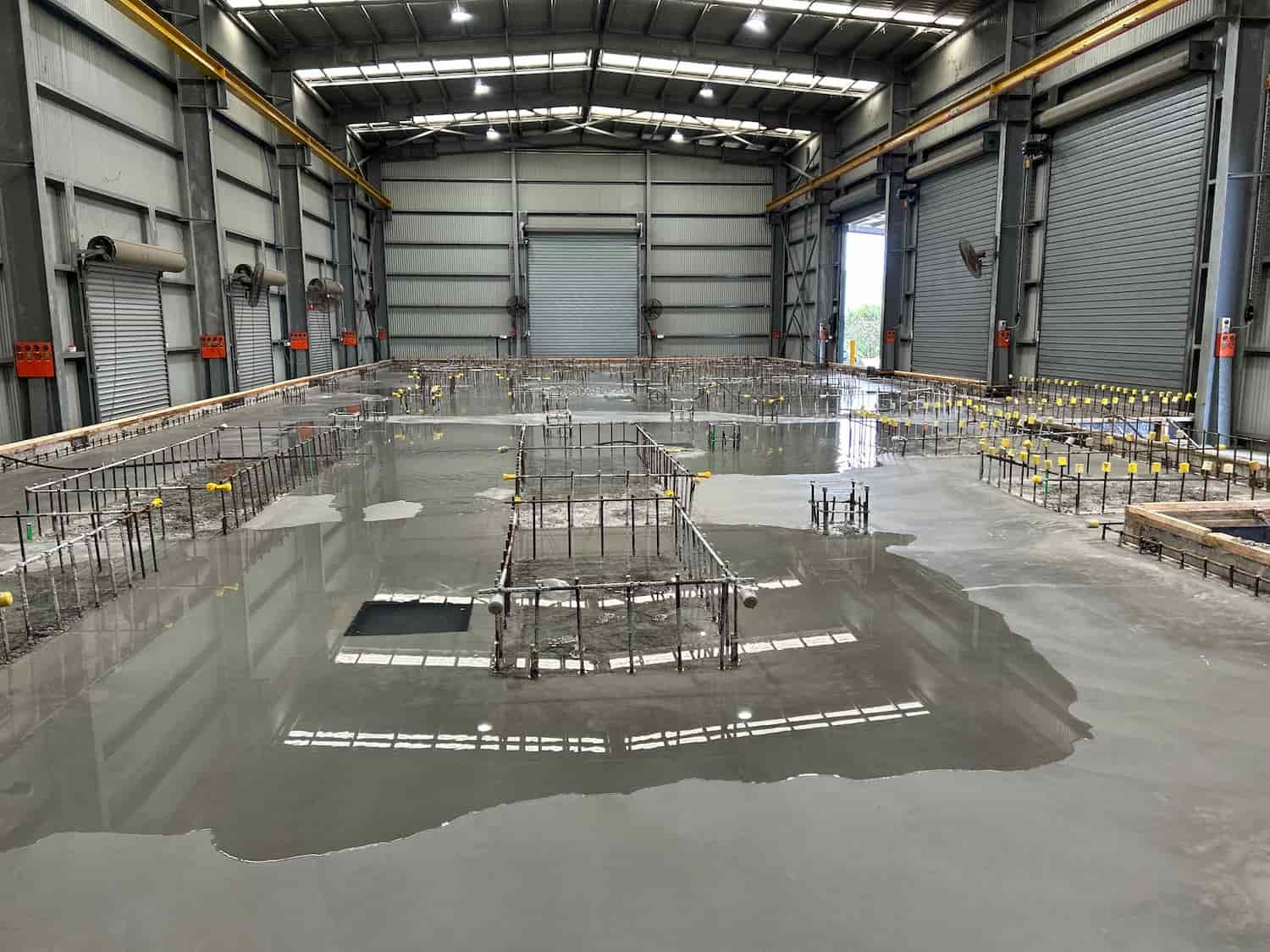 A Large Warehouse With a Lot of Concrete on the Floor — Diamond Concreting In Mount Low, QLD