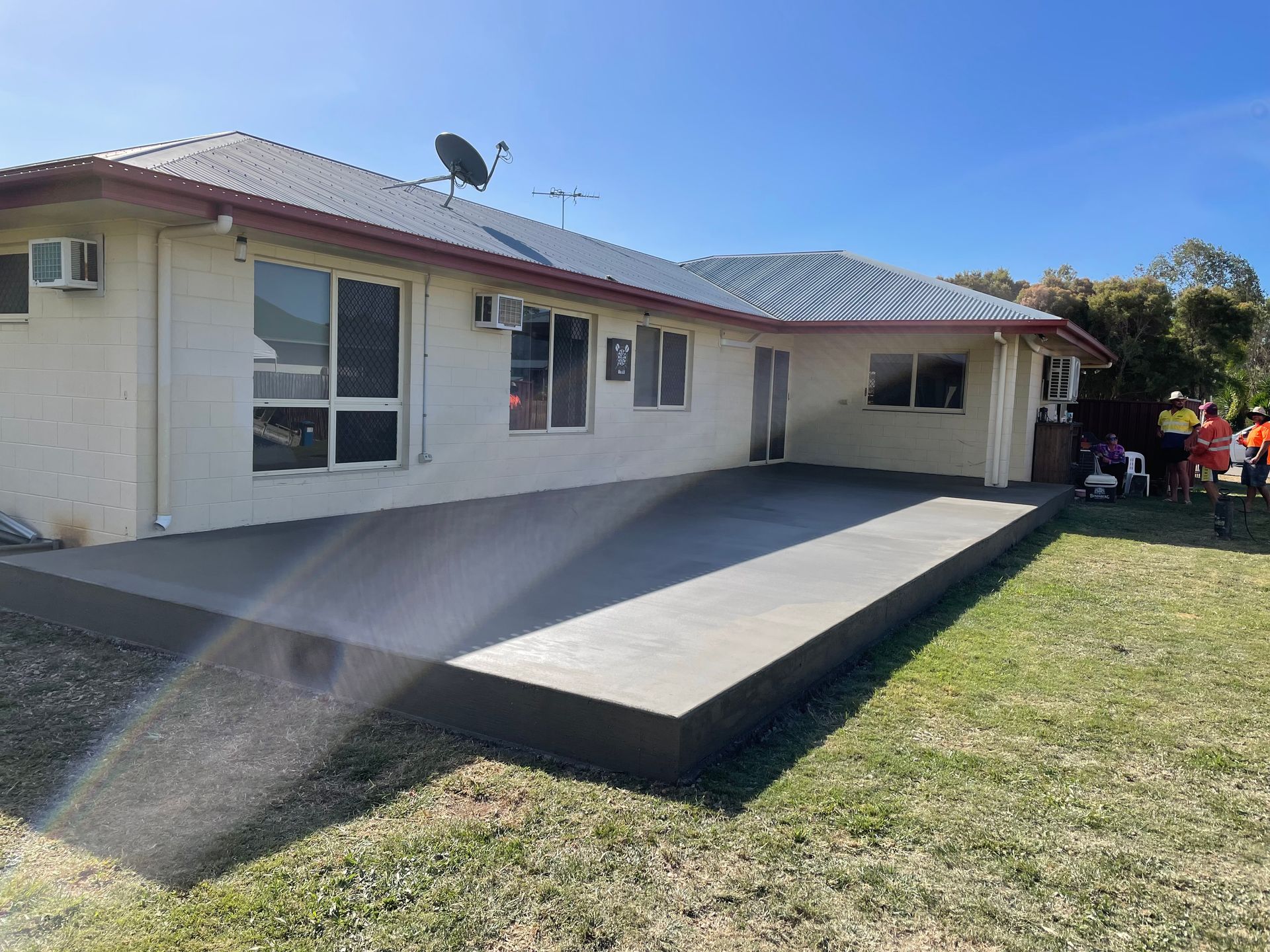 Large Apartment With A Concrete Courtyard In Front Of It — Diamond Concreting In Mount Low, QLD
