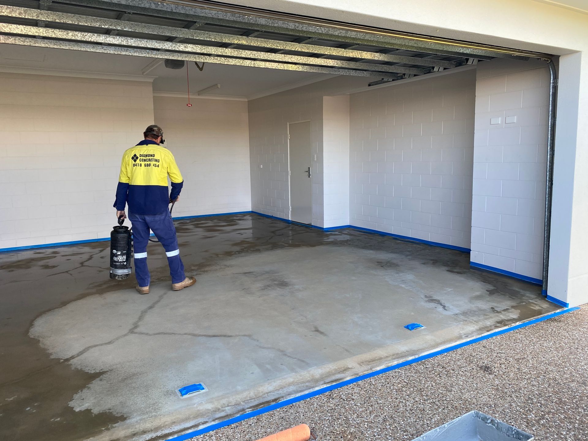 Paint Roller Laying On A Concrete Floor — Diamond Concreting In Mount Low, QLD