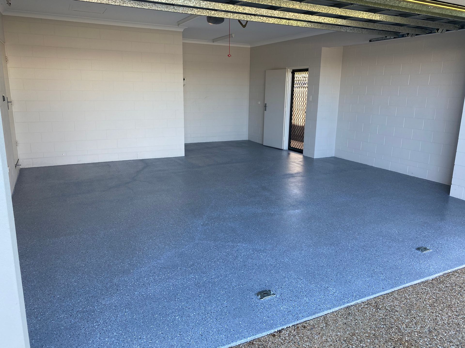 Person Painting A Floor With A Roller — Diamond Concreting In Mount Low, QLD