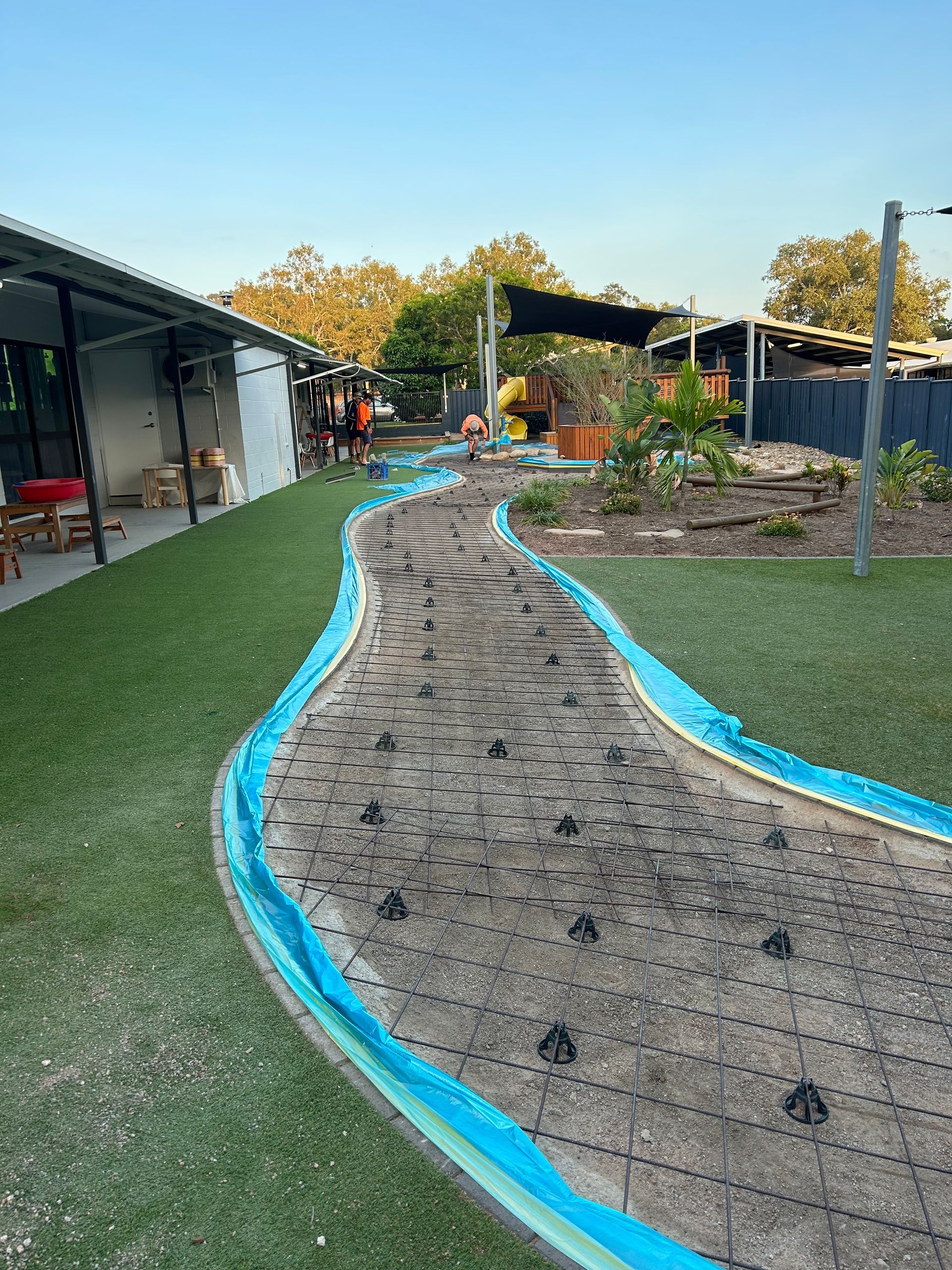 Brick Walkway Being Built In A Yard With A Wheelbarrow — Diamond Concreting In Mount Low, QLD