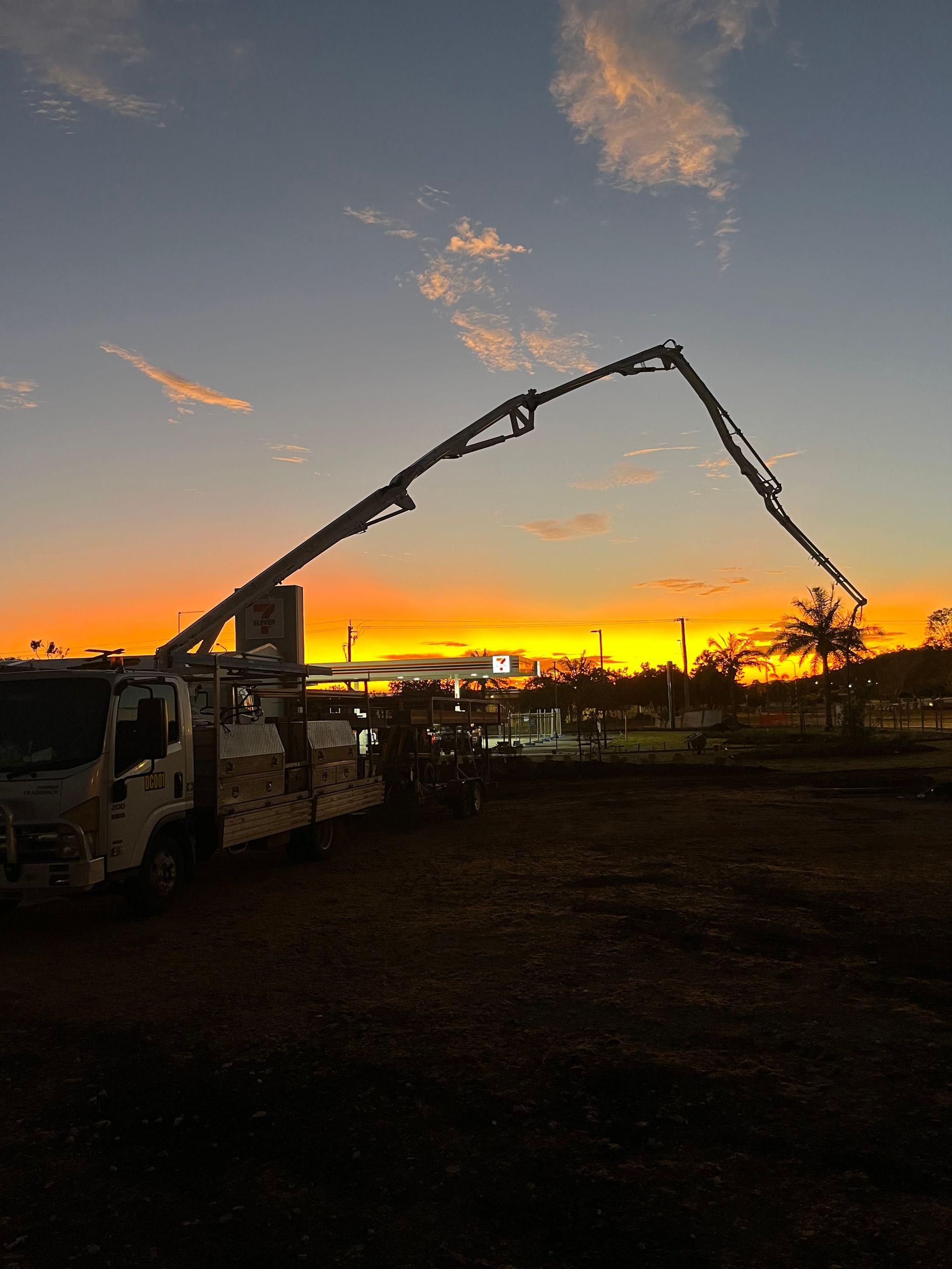 Man Pouring Concrete Into A Swimming Pool — Diamond Concreting In Mount Low, QLD