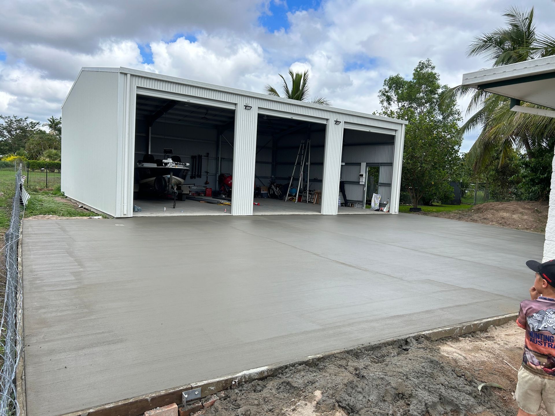 Dining Room With A Round Table And Chairs And A Large Window — Diamond Concreting In Mount Low, QLD