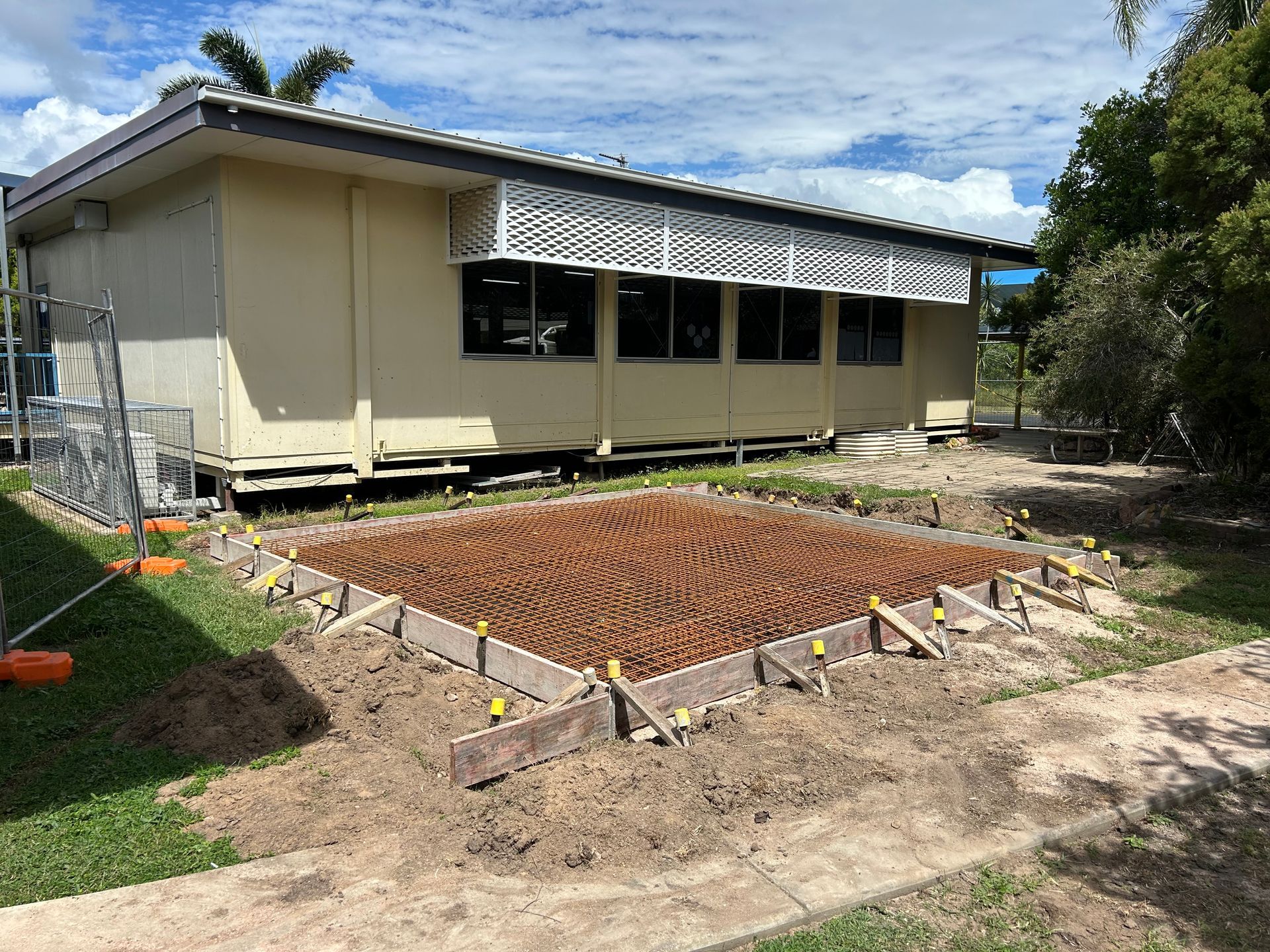 Brick Building With A Sliding Glass Door And Windows — Diamond Concreting In Mount Low, QLD