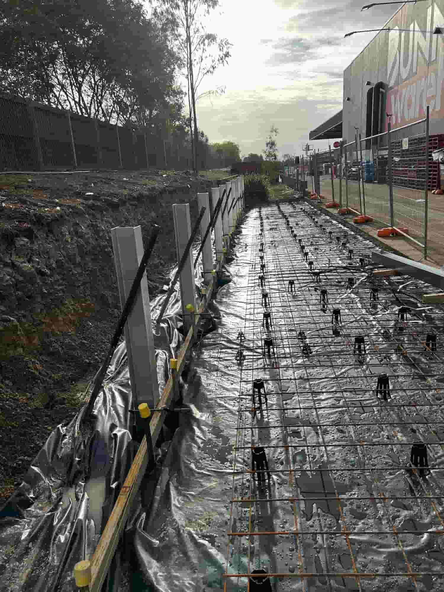 A Concrete Walkway is Being Built in Front of a Building — Diamond Concreting In Mount Low, QLD
