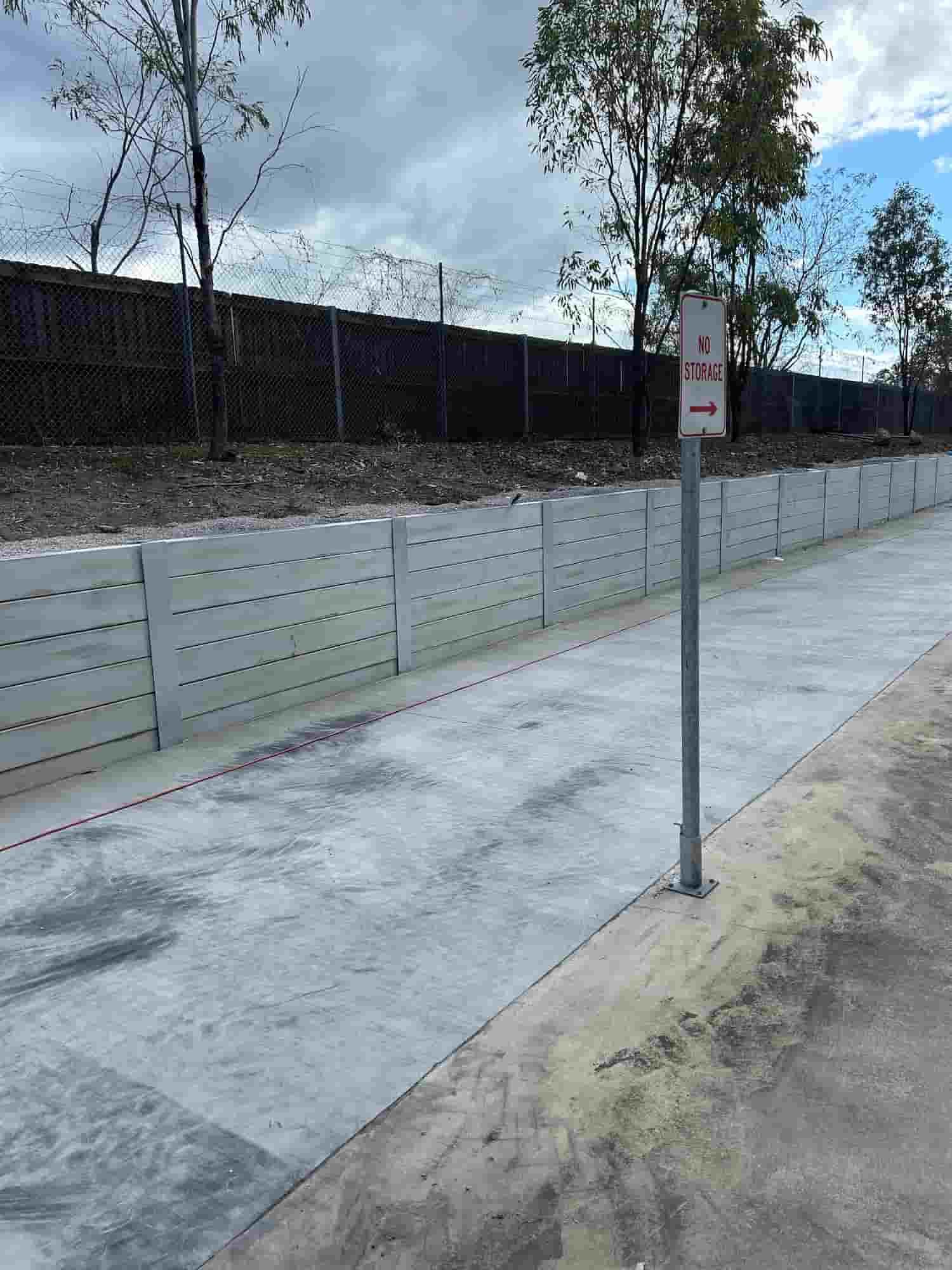 A Concrete Walkway With a Sign on the Side of It — Diamond Concreting In Mount Low, QLD