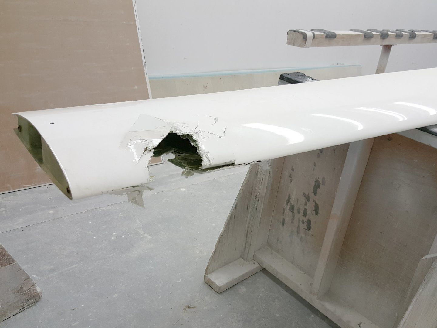 A white pipe with a hole in it is sitting on a table