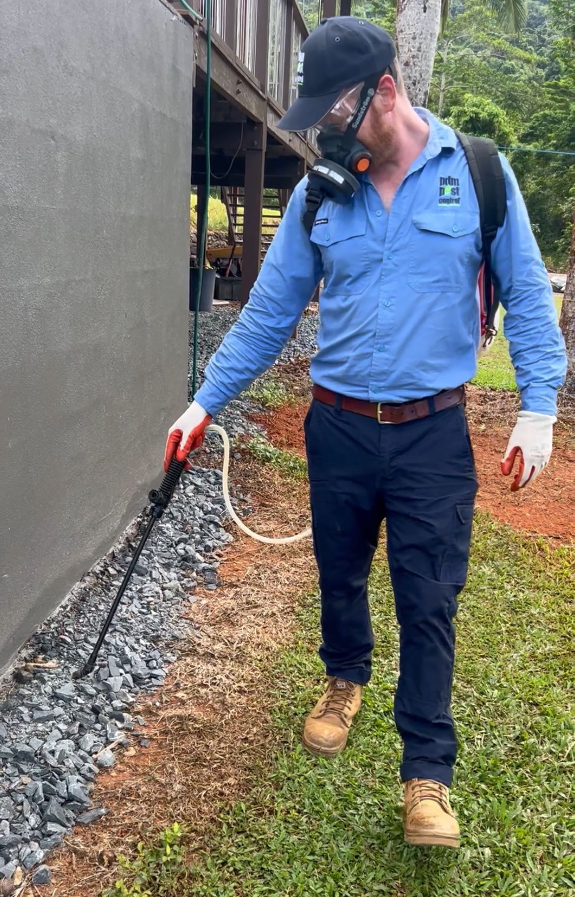 A Man Spraying Around The Home — PDM Pest Control in Craiglie, QLD