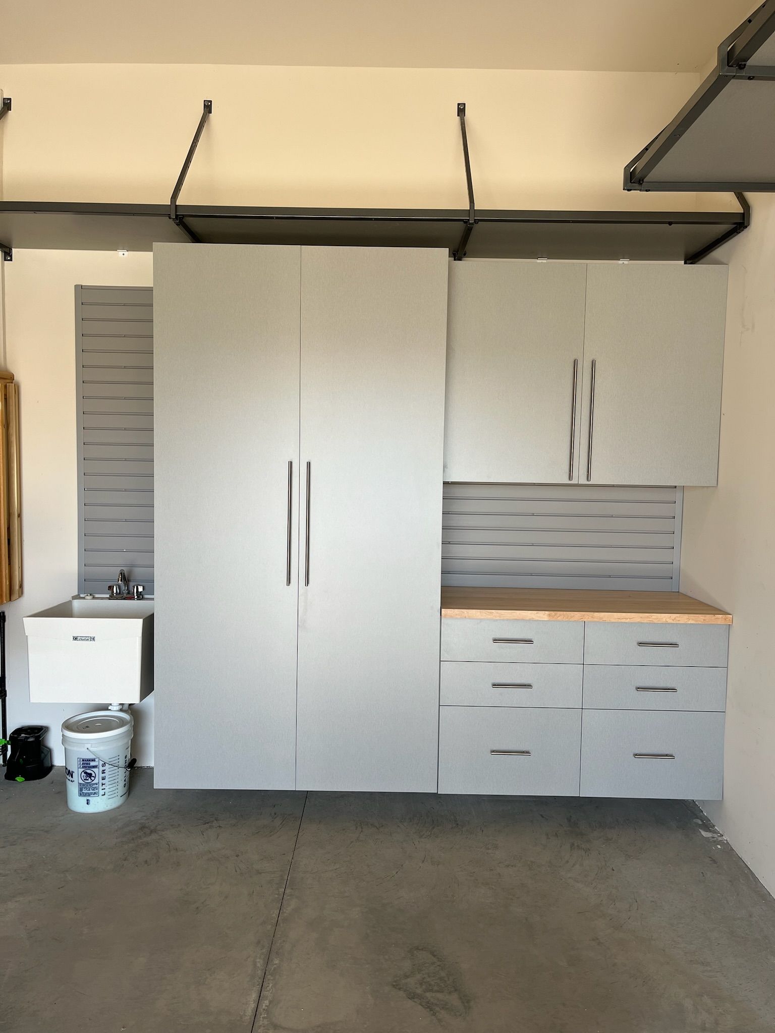 Garage storage cabinets and drawers mounted on a wall above a workbench area.