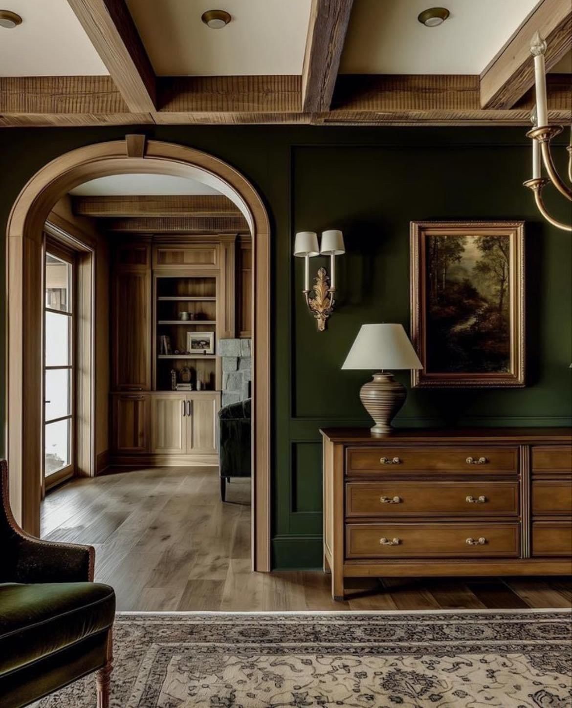 A living room with green walls and wooden furniture