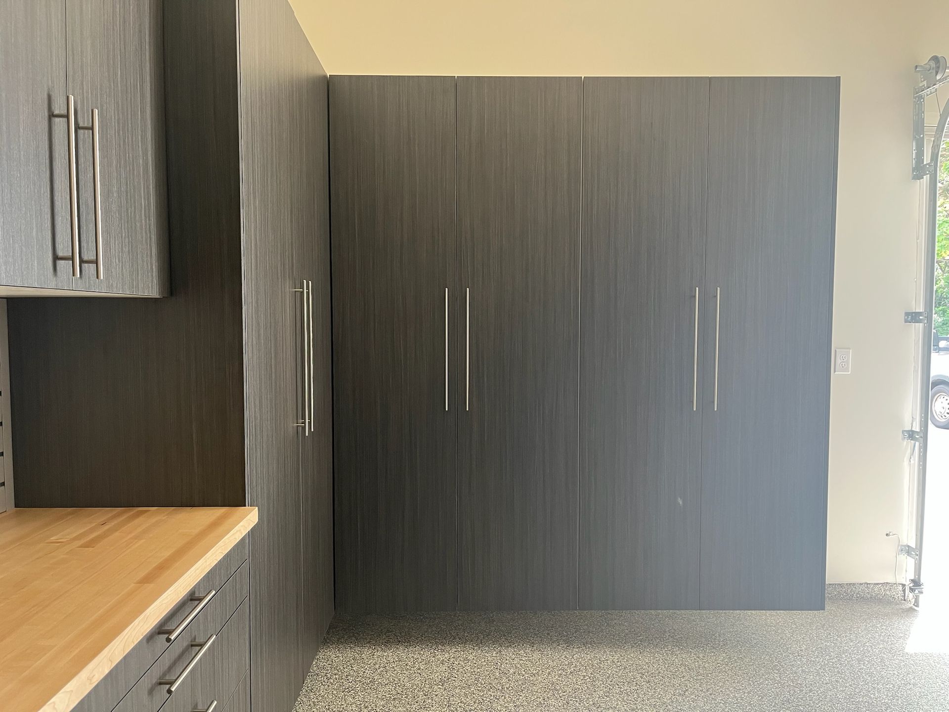 Modern kitchen corner with dark wood cabinets and a light wood countertop
