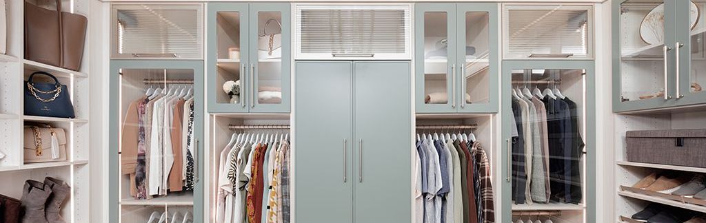 A walk in closet filled with lots of clothes and shoes.