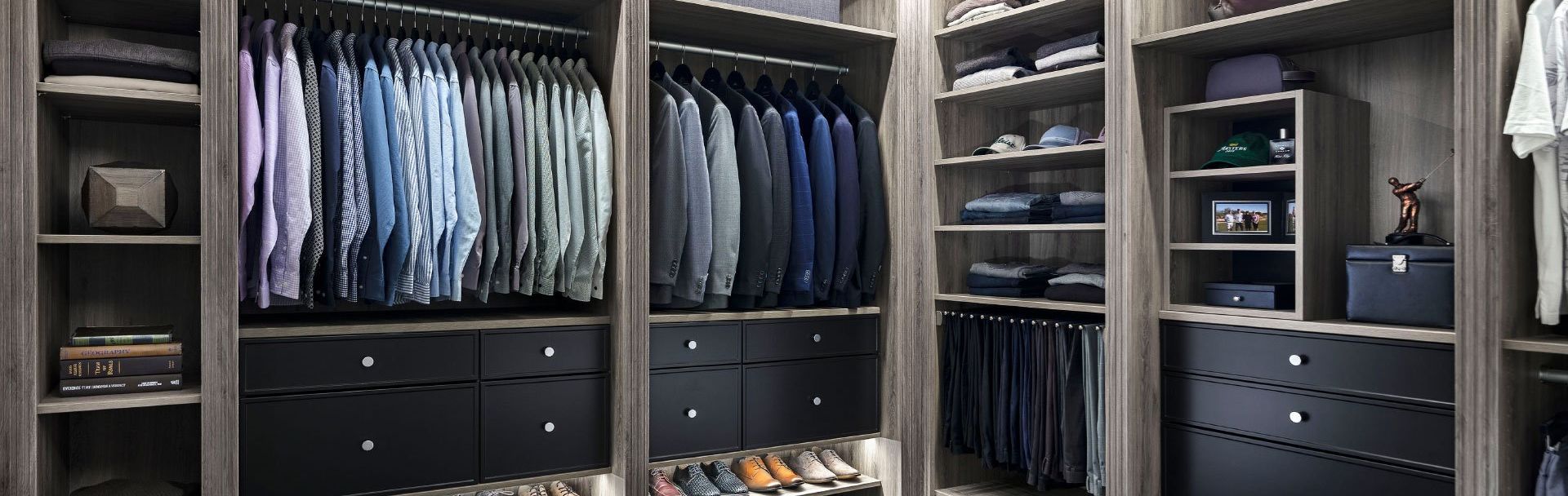 A walk in closet filled with lots of clothes and shoes.
