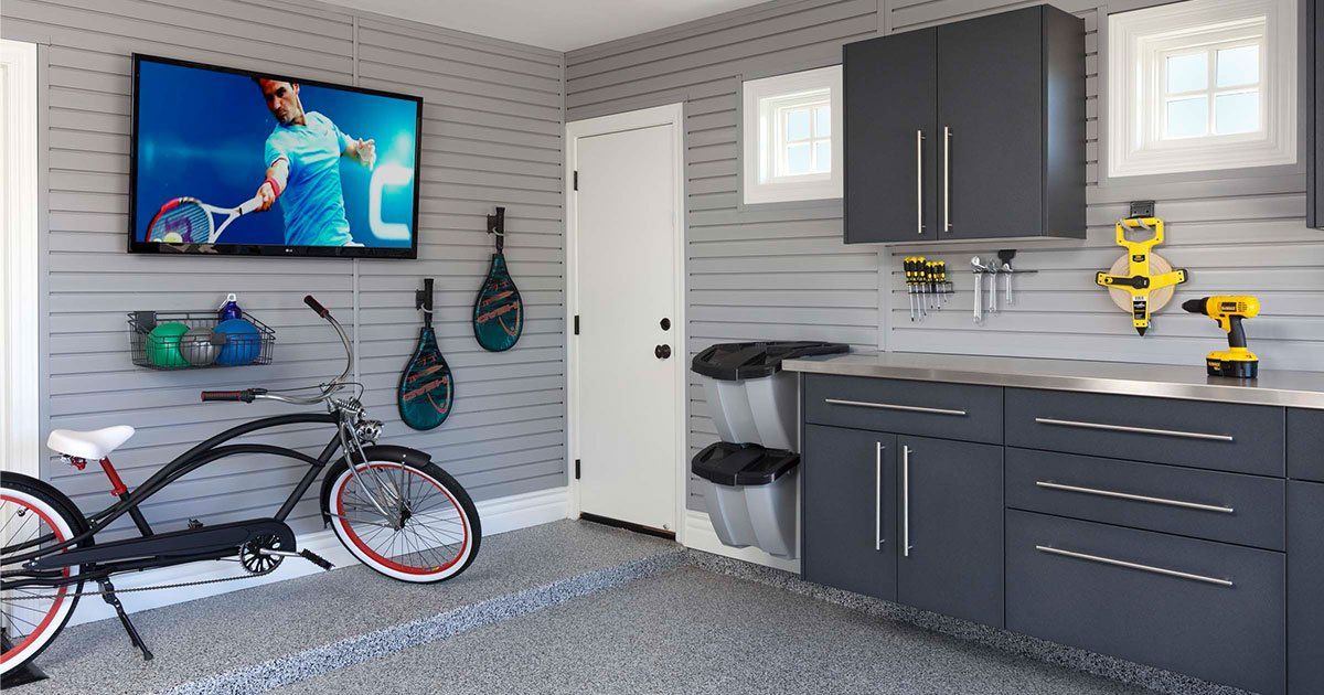 A bicycle is parked in a garage next to a television.