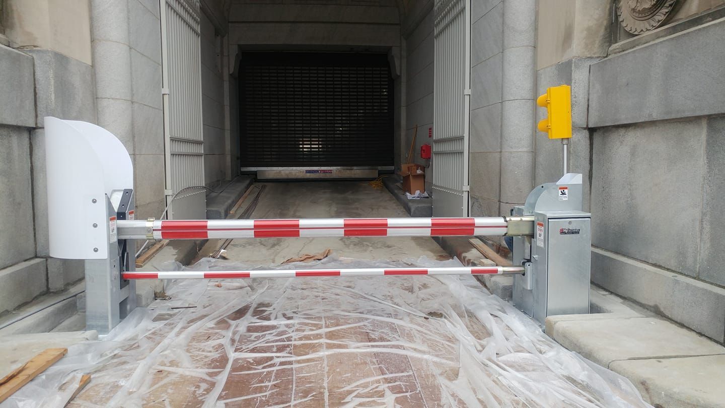 Blocked construction entrance with red-and-white barrier in front of a dark tunnel