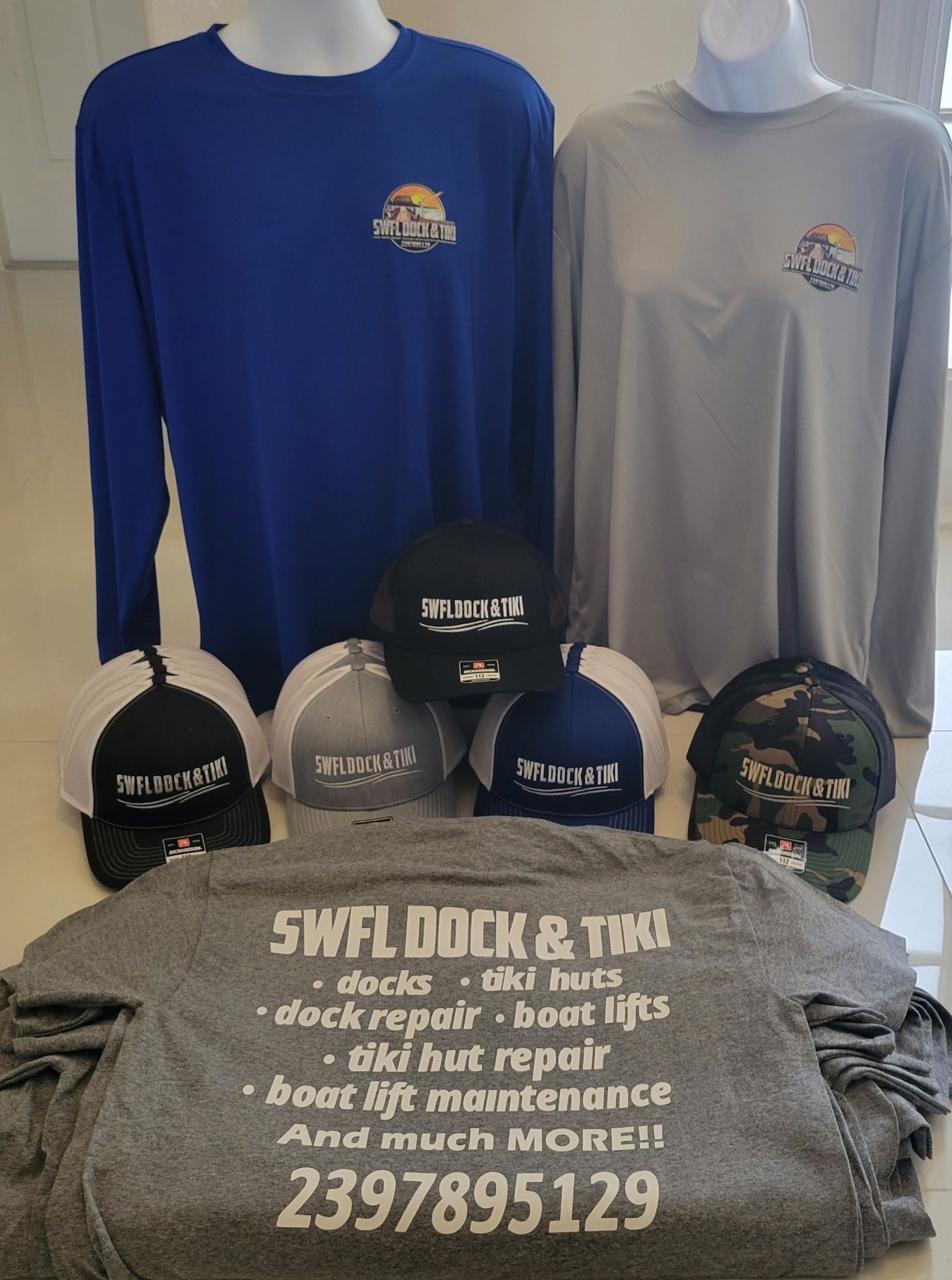 A bunch of hats and shirts are sitting on a table.