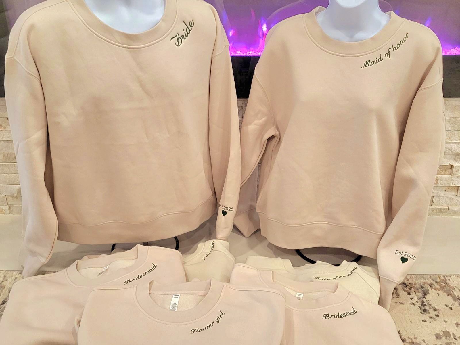 A couple of sweatshirts sitting on top of each other on a table.