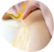 Wax being pulled from skin during hair removal treatment