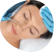 Person receiving a facial injection while lying on a treatment bed