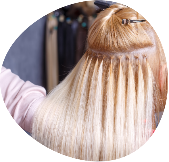 Close-up of blonde hair being sectioned with clips during a salon treatment