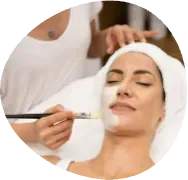 Cosmetologist applying a facial treatment to a client with a syringe in a spa setting