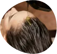Close-up of a person with wet dark hair and a yellow flower clip near the scalp