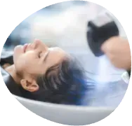 Person lying down with eyes closed while a caregiver holds a stethoscope nearby