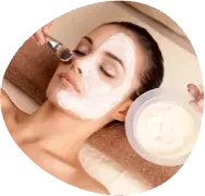 Woman receiving a facial mask treatment while lying on a spa bed