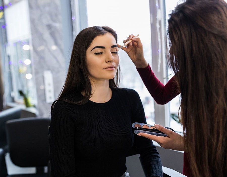 Woman having makeup applied in a salon