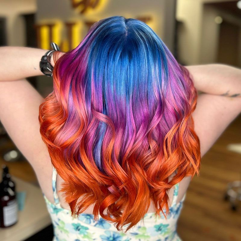 Back view of wavy hair dyed blue, purple, pink, and orange