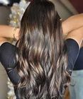Back view of long wavy dark brown hair with lighter highlights.