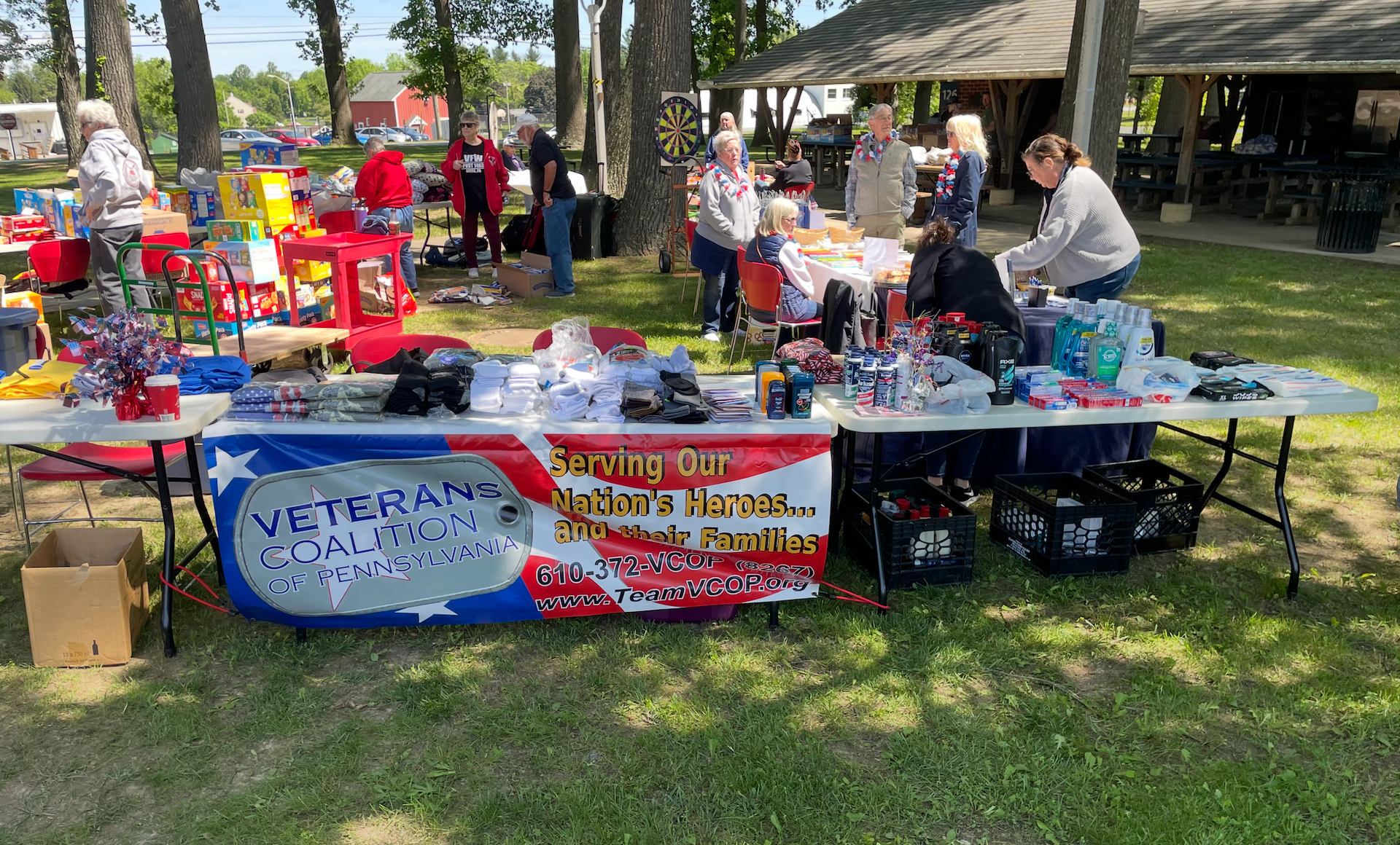 Outdoor sale with a banner that reads 