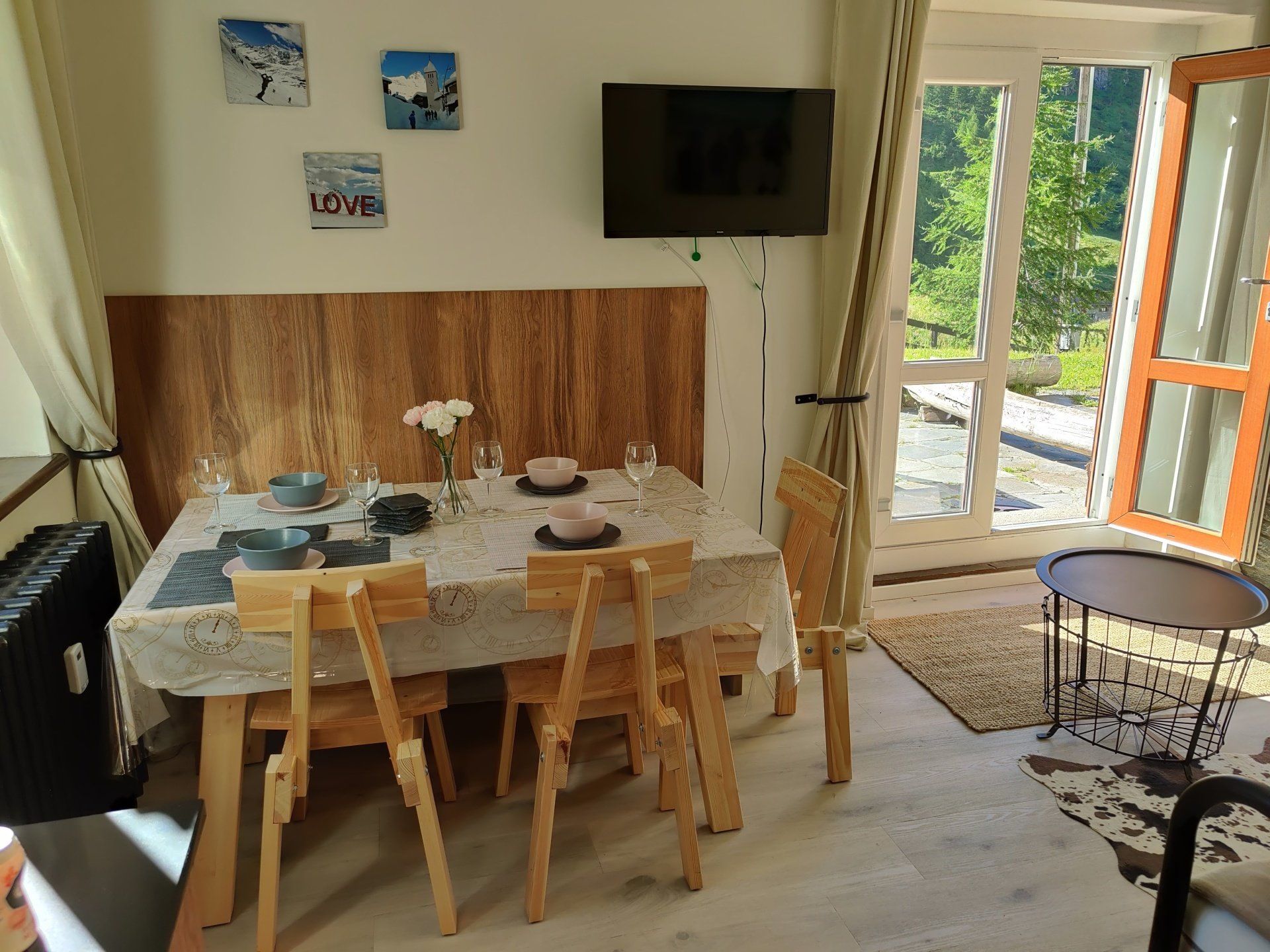 Living room with a set table for 4 people.