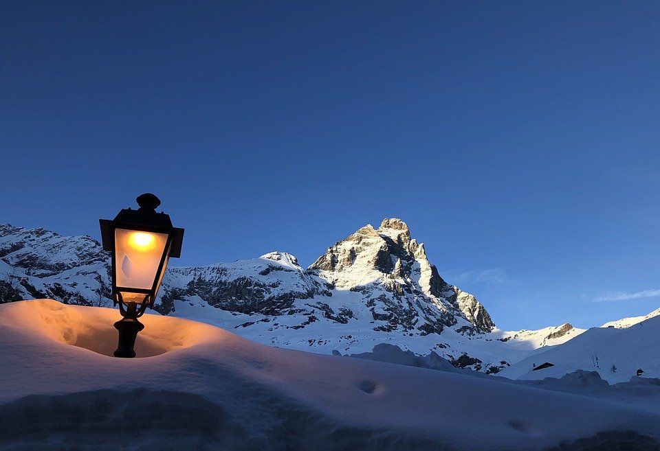 The matterhorn covered in snow with a street lantern
