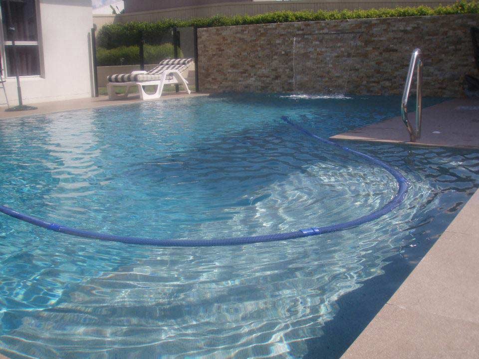 Water Hose In The Pool — Bundaberg, QLD — JJ's Pools & Spas